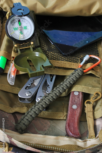 Compass, knife and multitool in a backpack