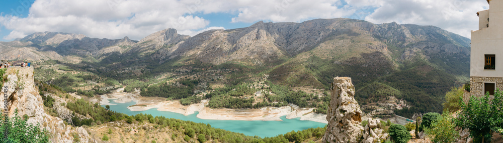 Guadalest in Spain. Panoramic views of the mountains, lake and castle ruins.