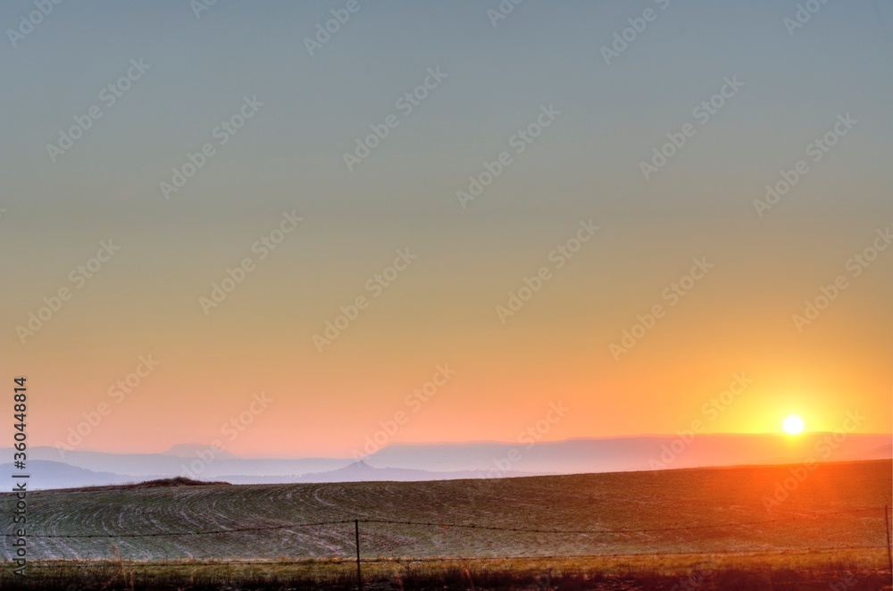 Southern Drakensberg,  looking east into a sun rising over the foothills of the southern drakensberg, Kwazulu Natal