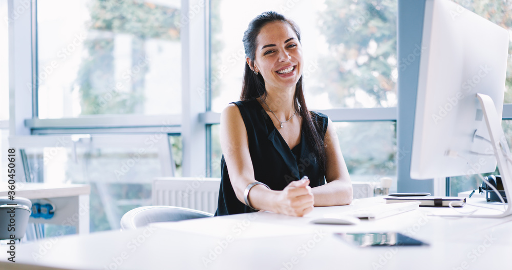 Portrait of cheerful employer of business enterprise enjoying creative working process in modern office indoors, young administrative manager satisfied with occupation planning project using computer Portrait of cheerful employer of business enterprise enjoying creative working process in modern office indoors, young administrative manager satisfied with occupation planning project using computer
