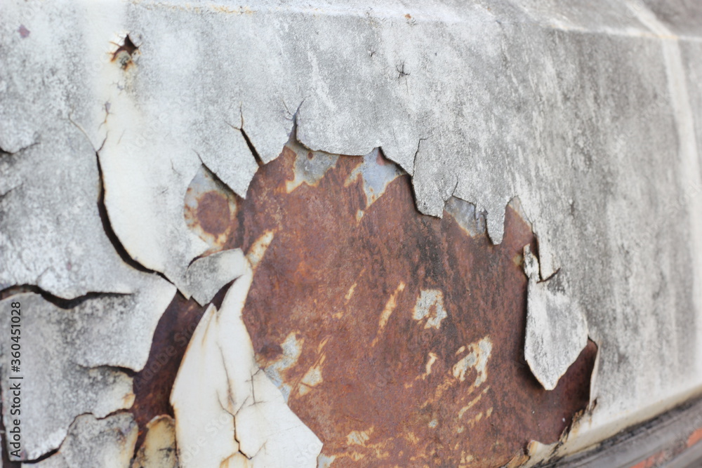 Blurred crack, peeling paint or rust on a car texture background