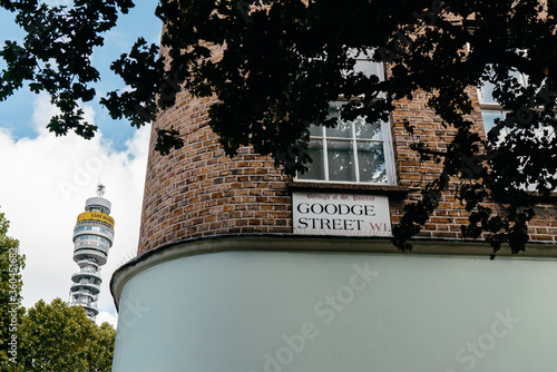 Photography London, UK - 14 June, 2020;
Goodge street name sign on the building, low angle view, and BT tower is on the side background