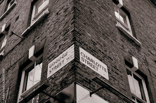 Photography London, UK - 14 June, 2020;
Goodge street name sign on the building, low angle view, and BT tower is on the side background