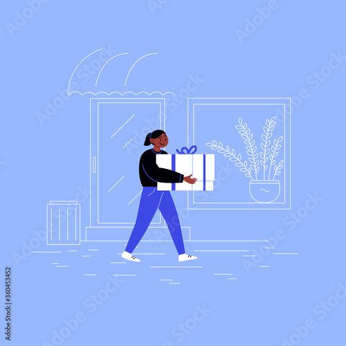Delivery girl on her way to a client with a box walking down the street wearing 