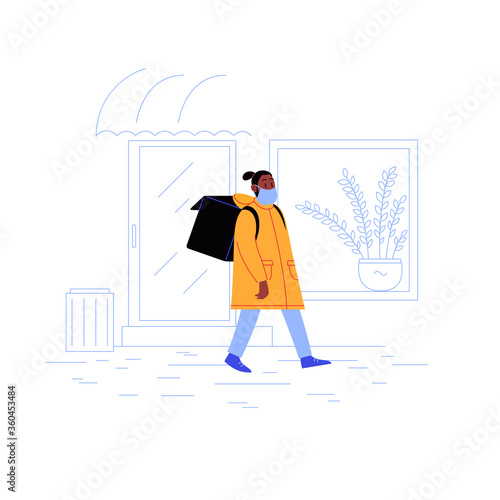 Delivery guy on his way to a client with a thermobag walking down the street wearing medical face mask