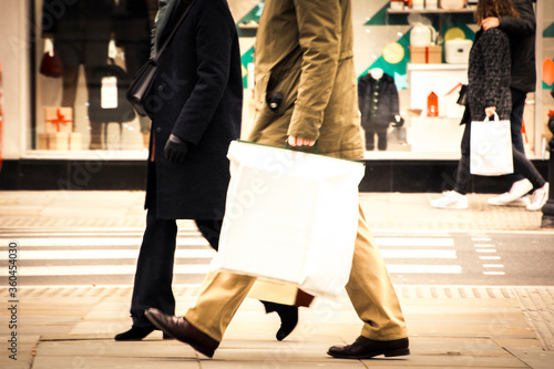 Anonymous high street shoppers carrying shopping bags