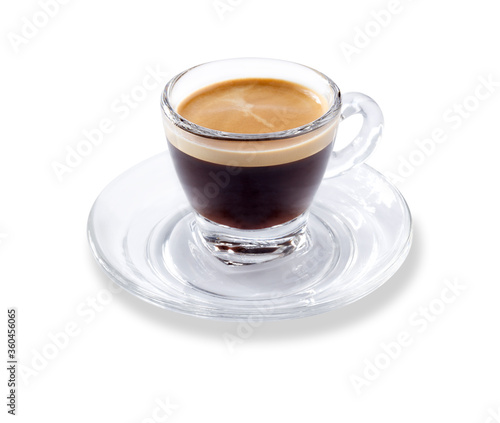 Angled view of a modern glass expresso cup and saucer full of smooth expresso coffee, isolated on white