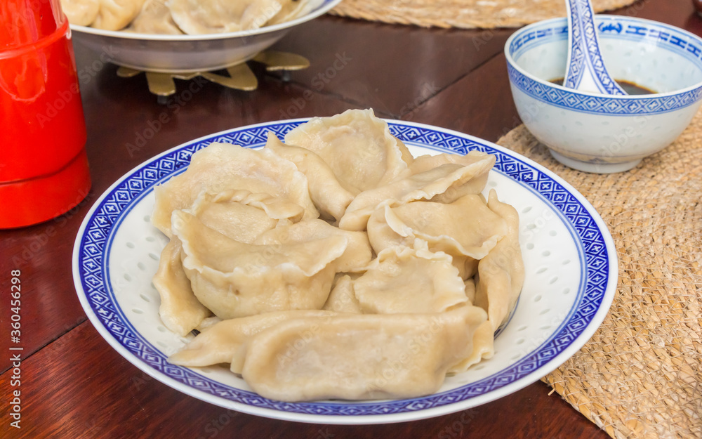 Homemade chinese dumplings, cooked in water, served with soy sauce Homemade chinese dumplings, cooked in water, served with soy sauce