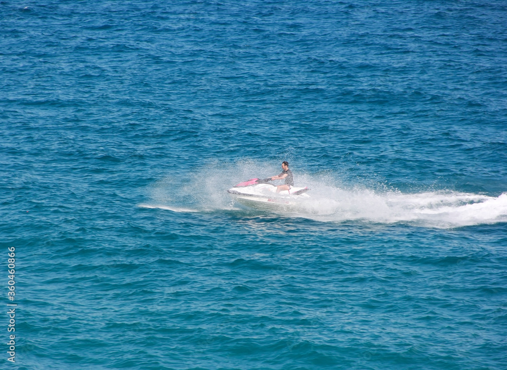 Antalya, Turkey, may 25, 2020. A man drives a jet ski on the waves of the blue sea