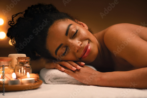 Closeup of joyful black lady sleeping at spa salon