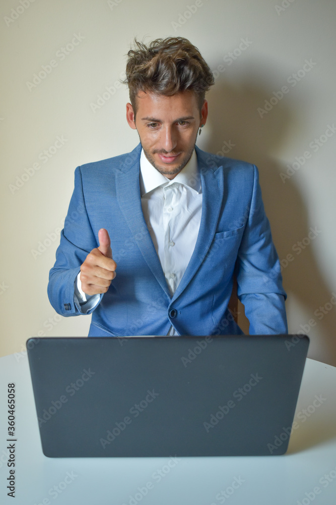 Businessman video calling and giving directions through laptop Businessman video calling and giving directions through laptop