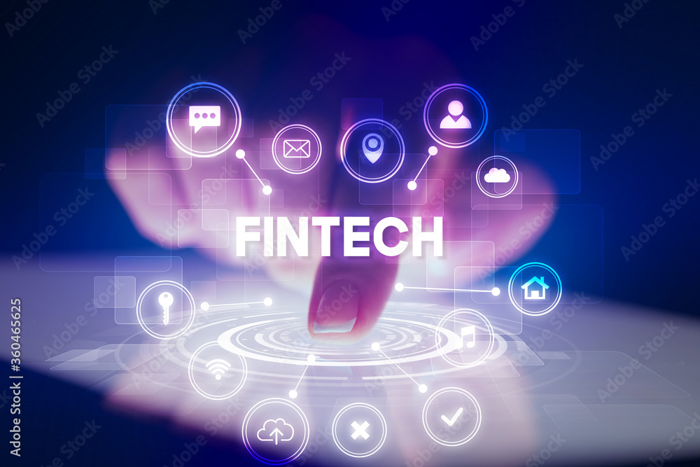 Finger touching tablet with web technology icons and FINTECH inscription, web technology concept Finger touching tablet with web technology icons and FINTECH inscription, web technology concept