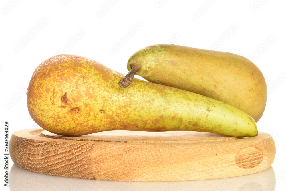 Two juicy pears on a wooden tray on a white background. Two juicy pears on a wooden tray on a white background.