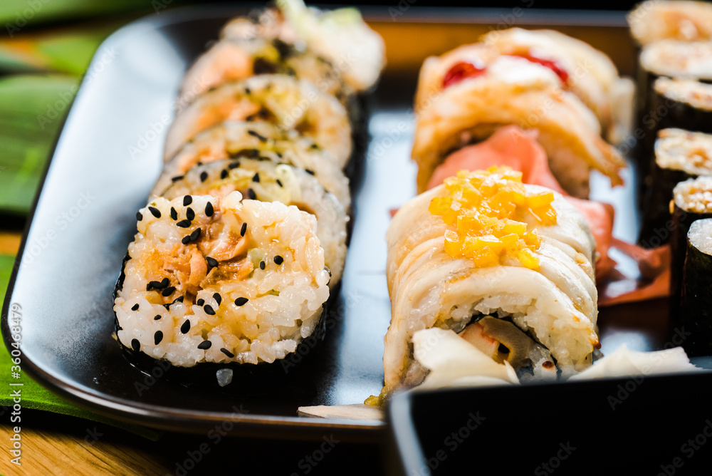 Sushi and roll set on wooden table. Selective focus Sushi and roll set on wooden table. Selective focus