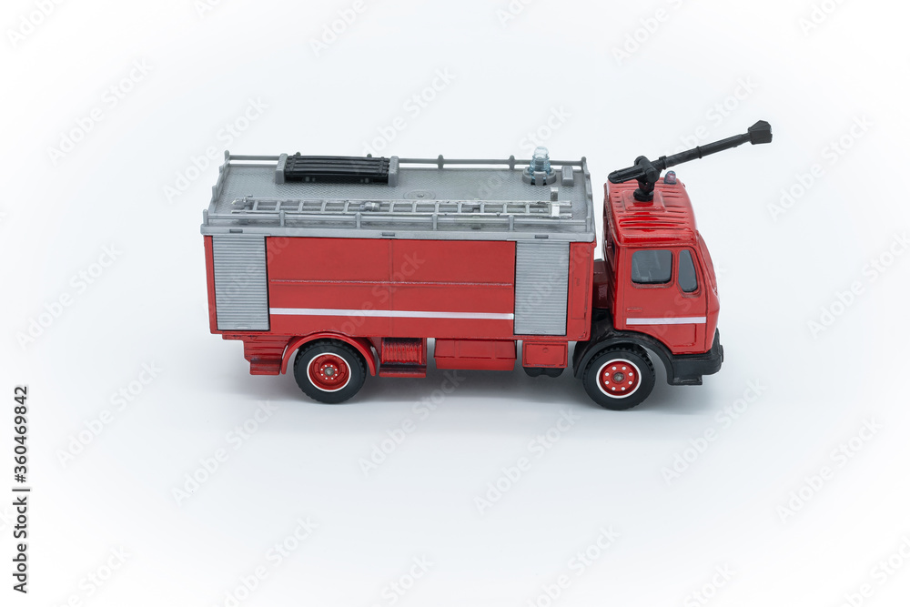 Children toy Red fire truck with a ladder on a white background