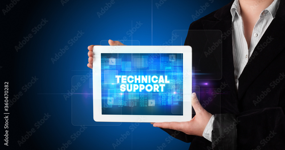 Young business person working on tablet and shows the inscription: TECHNICAL SUPPORT Young business person working on tablet and shows the inscription: TECHNICAL SUPPORT