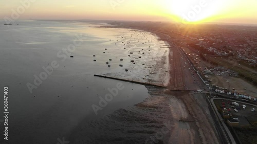 Aerial view of boats moored at Thorpe Bay at sunset and Southend-on Sea pier in the distance photo