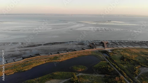 Flying over Gunners Park towards the Barge Pier in the Thames Estuary at sunset photo