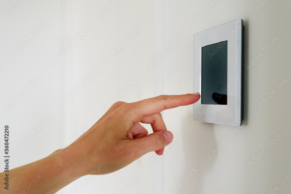 Hand using Air ventilation controller with display Hand using Air ventilation controller with display