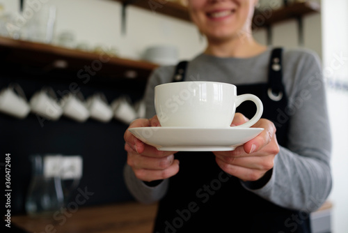 Woman waitress with cup smiling