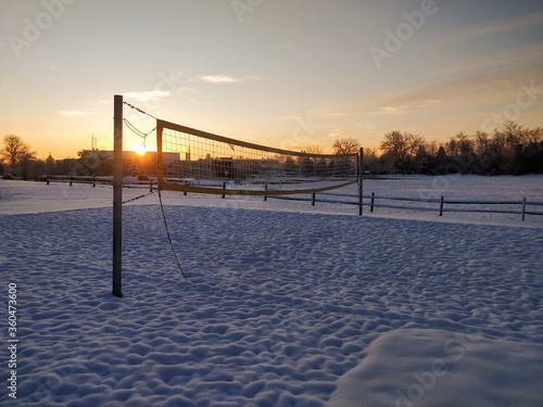 Sunrise behind a snowy volleyball net © Andreas