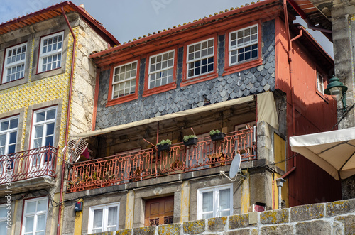 Historic old city buildings facades and with clean laundry on balconies, Porto, Portugal © Zkolra