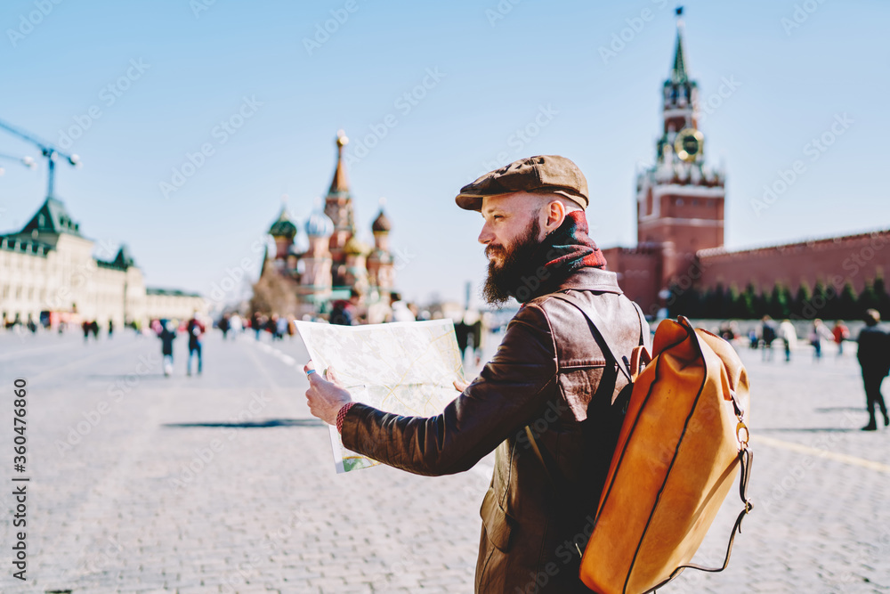 Man with backpack walking with tourist map on Red Square