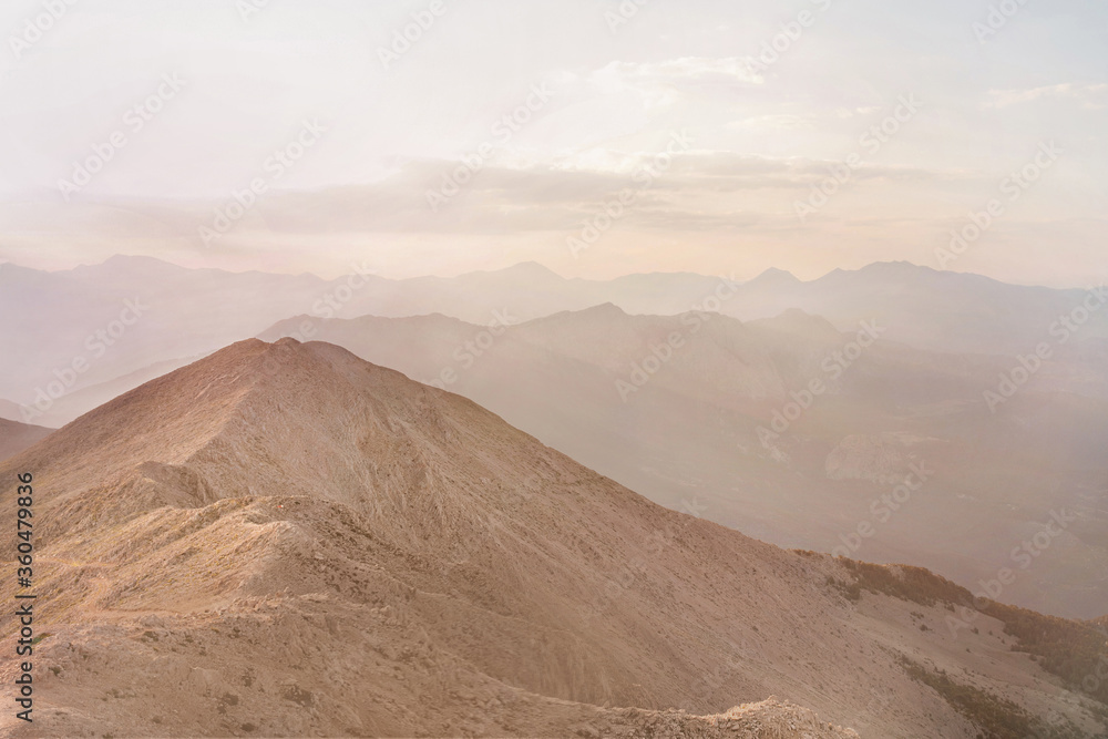 Naklejka premium Mountain peaks in fog scenery landscape