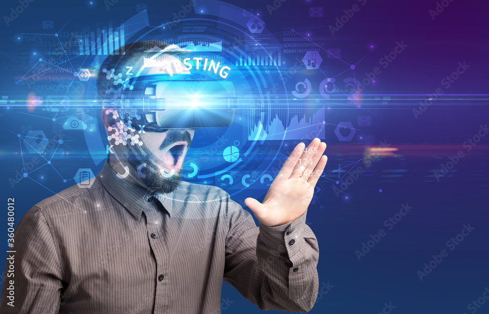 Businessman looking through Virtual Reality glasses with TESTING inscription, innovative technology concept Businessman looking through Virtual Reality glasses with TESTING inscription, innovative technology concept