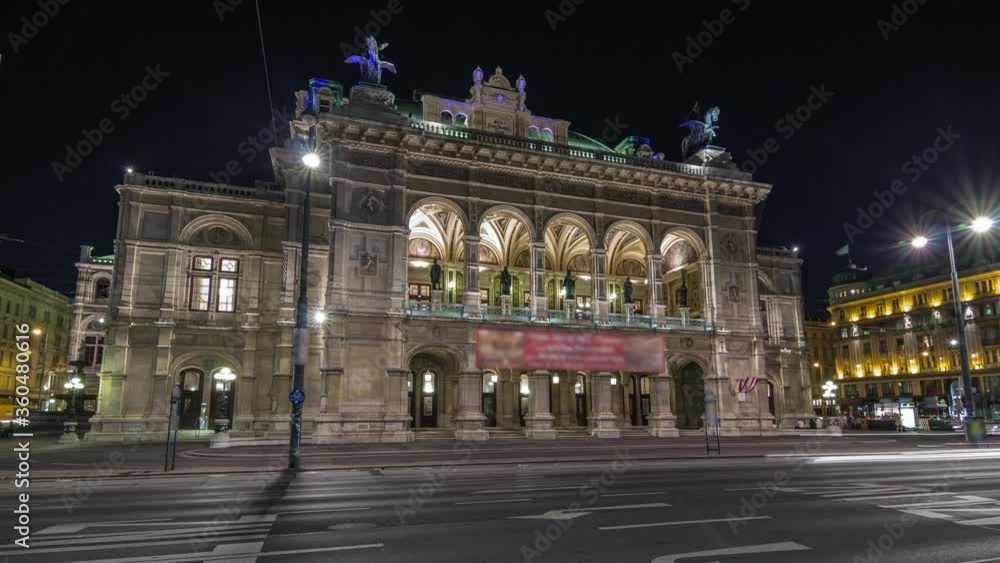 Beautiful view of Wiener Staatsoper (Vienna State Opera) night timelapse hyperlapse in Vienna, Austria. Illuminated historic buildings and traffic on streets Beautiful view of Wiener Staatsoper (Vienna State Opera) night timelapse hyperlapse in Vienna, Austria. Illuminated historic buildings and traffic on streets