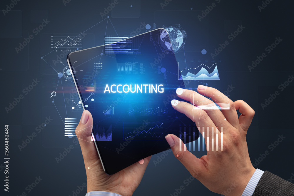 Businessman holding a foldable smartphone with ACCOUNTING inscription, successful business concept Businessman holding a foldable smartphone with ACCOUNTING inscription, successful business concept