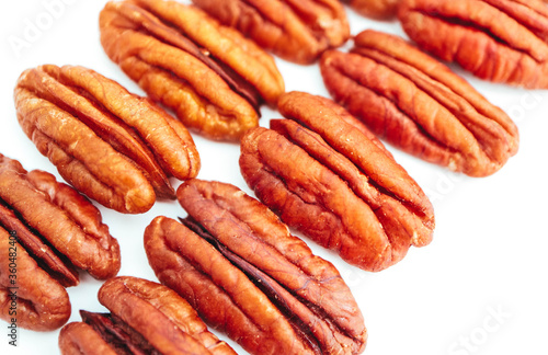A group of raw pecan nuts, isolated on white background.