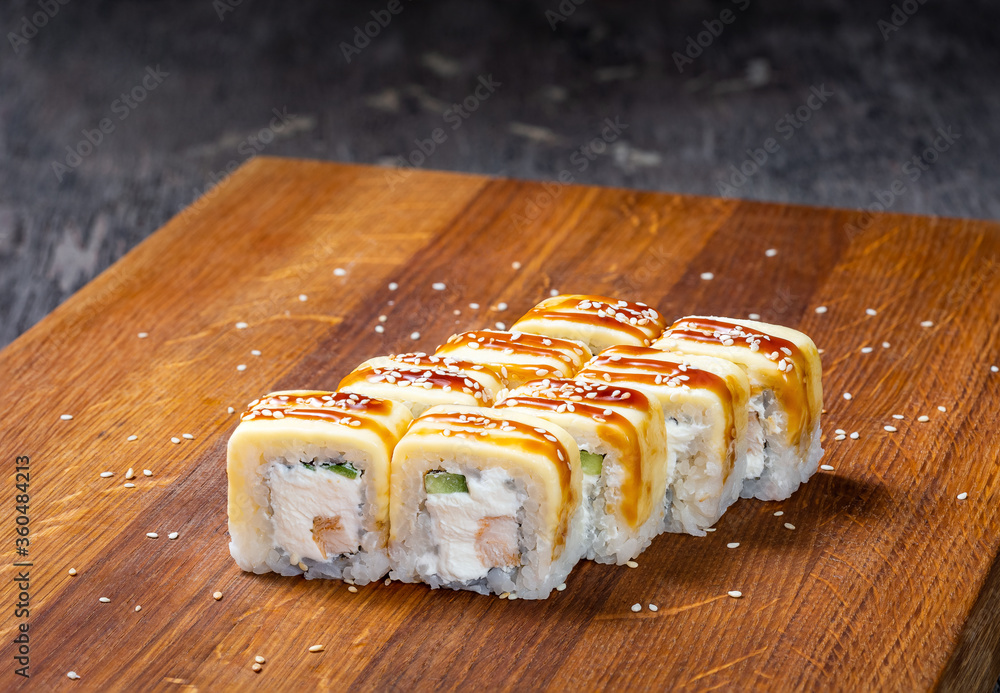 Japanese cuisine. Seafood, vegetables and meat. Sushi and rolls big set isolation on a wooden table background