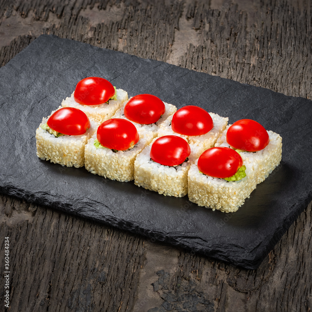 Japanese cuisine. Seafood, vegetables and meat. Sushi and rolls big set isolation on a wooden table background