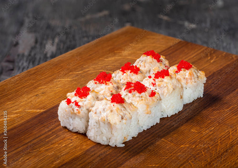 Japanese cuisine. Seafood, vegetables and meat. Sushi and rolls big set isolation on a wooden table background