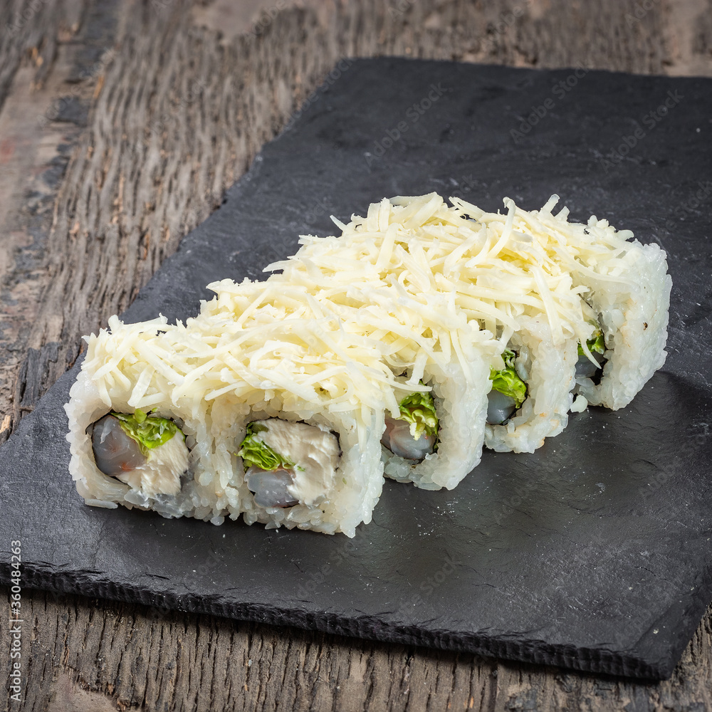 Japanese cuisine. Seafood, vegetables and meat. Sushi and rolls big set isolation on a wooden table background