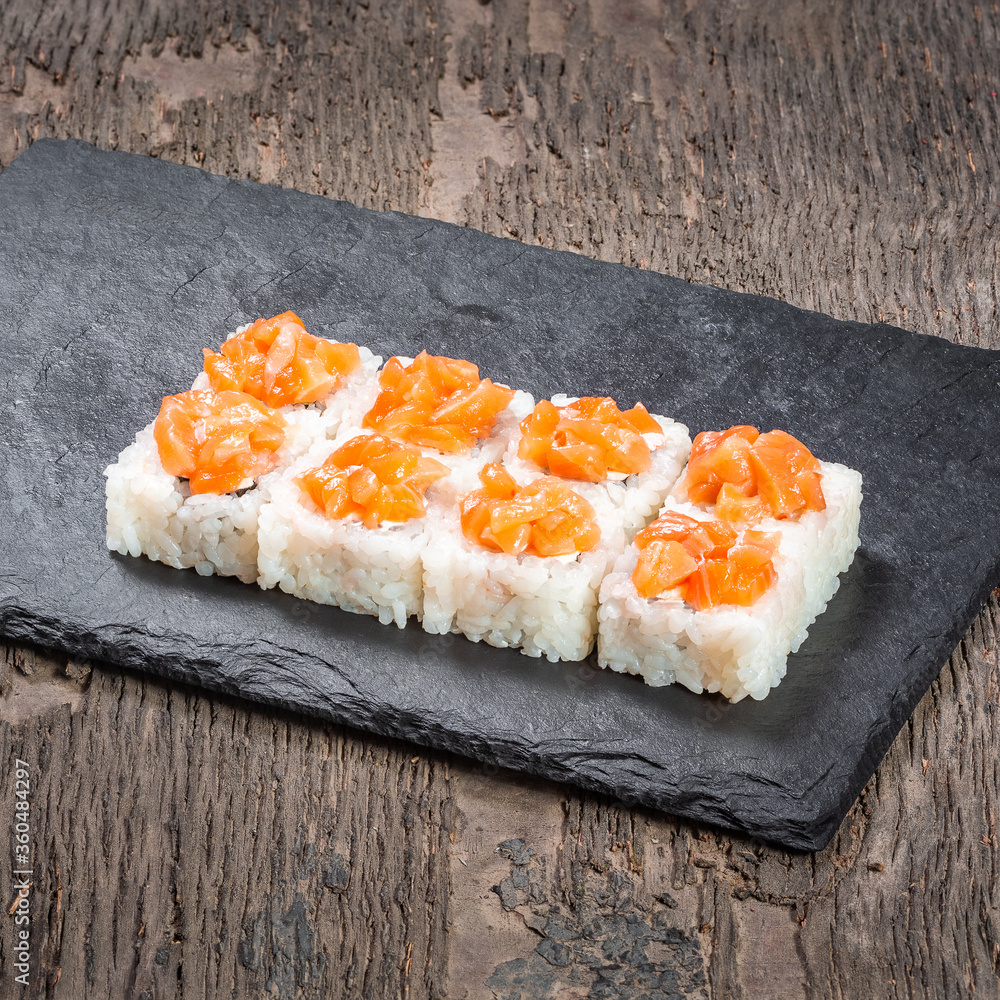 Japanese cuisine. Seafood, vegetables and meat. Sushi and rolls big set isolation on a wooden table background