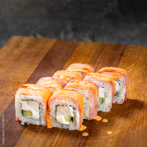Obraz na płótnie Japanese cuisine. Seafood, vegetables and meat. Sushi and rolls big set isolation on a wooden table background w salonie