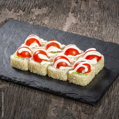 Obraz na płótnie Japanese cuisine. Seafood, vegetables and meat. Sushi and rolls big set isolation on a wooden table background w salonie