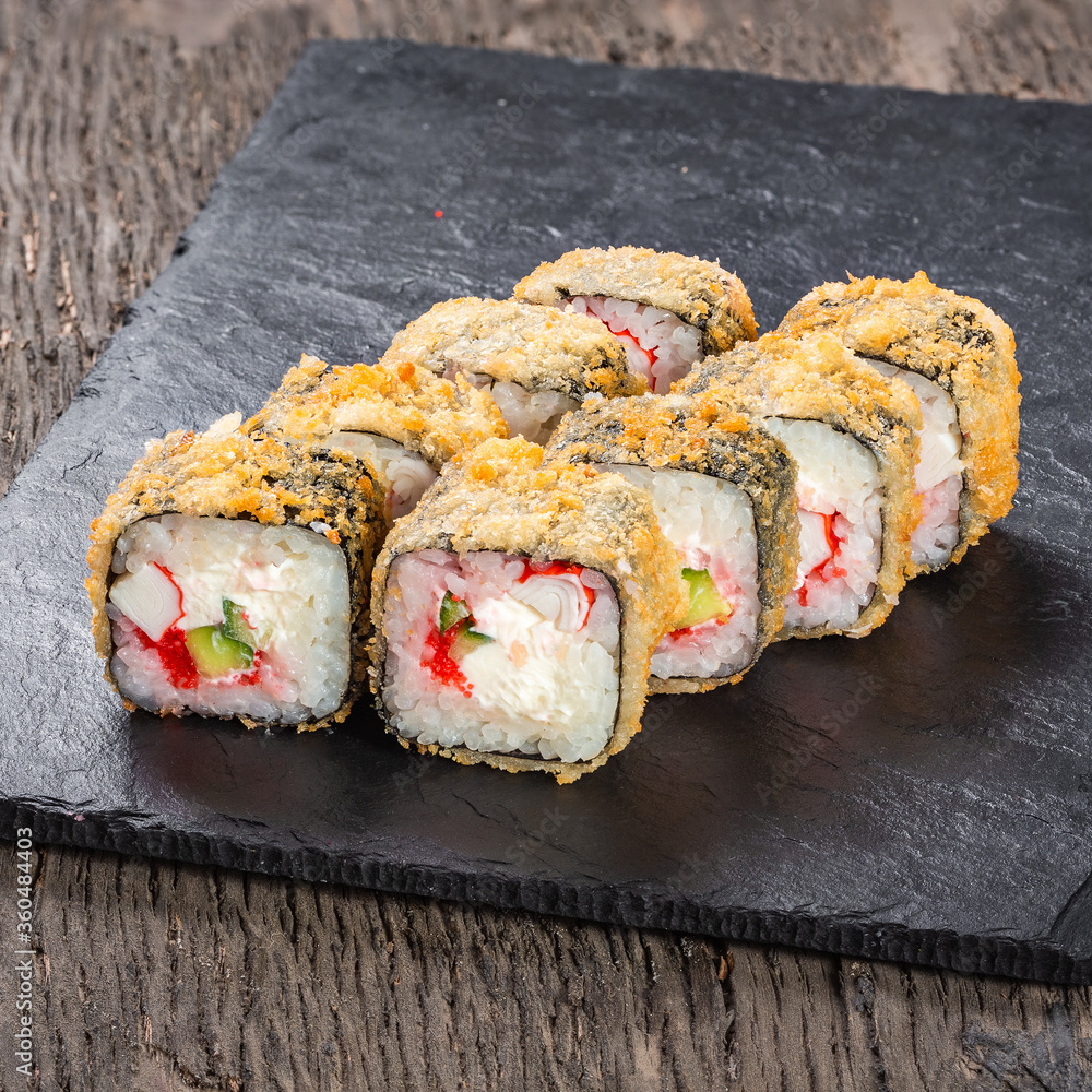 Japanese cuisine. Seafood, vegetables and meat. Sushi and rolls big set isolation on a wooden table background