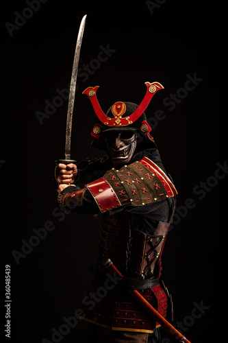 Fototapeta Portrait of a samurai in armor in attack position