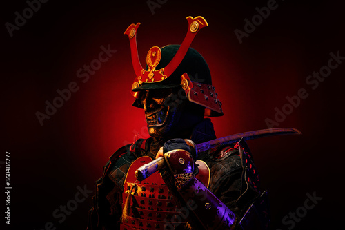 Portrait of a samurai in red armor in profile, his katana on his shoulder