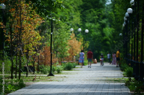 Blurred background. People relax in the city Park.