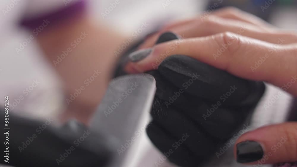 Beautician with file filing nails client woman spa beauty salon slow motion Beautician with file filing nails client woman spa beauty salon slow motion
