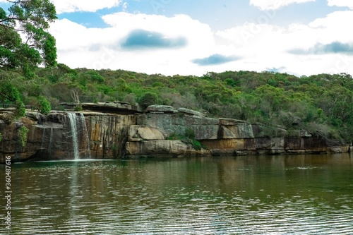 Panoramic views of Wattamolla Beach with waterfall tress turquoise blue waters and nice white sandy beach in sydney NSW Australia