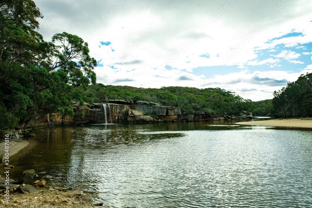 Panoramic views of Wattamolla Beach with waterfall tress turquoise blue waters and nice white sandy beach in sydney NSW Australia Panoramic views of Wattamolla Beach with waterfall tress turquoise blue waters and nice white sandy beach in sydney NSW Australia