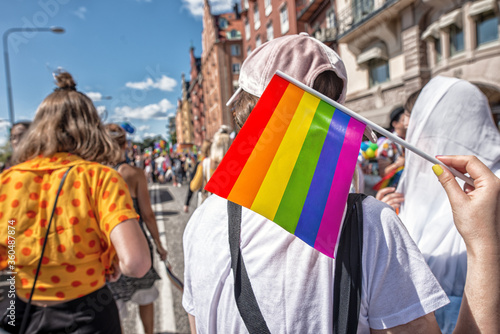 Canvas Print Pride flag in human hand on a pride parade