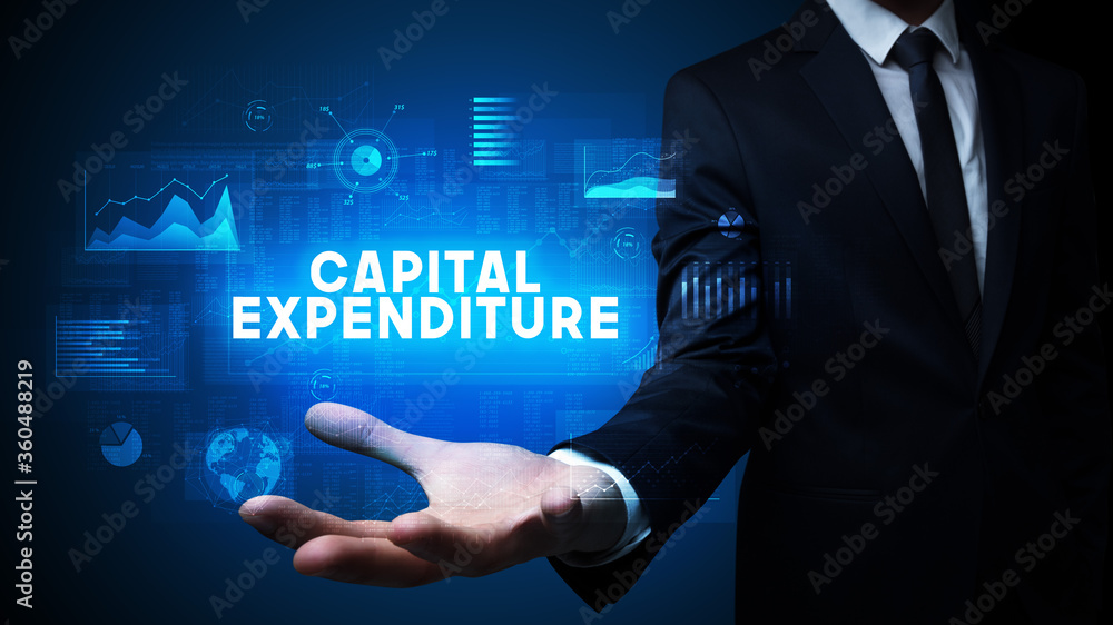 Hand of Businessman holding CAPITAL EXPENDITURE inscription, business success concept Hand of Businessman holding CAPITAL EXPENDITURE inscription, business success concept