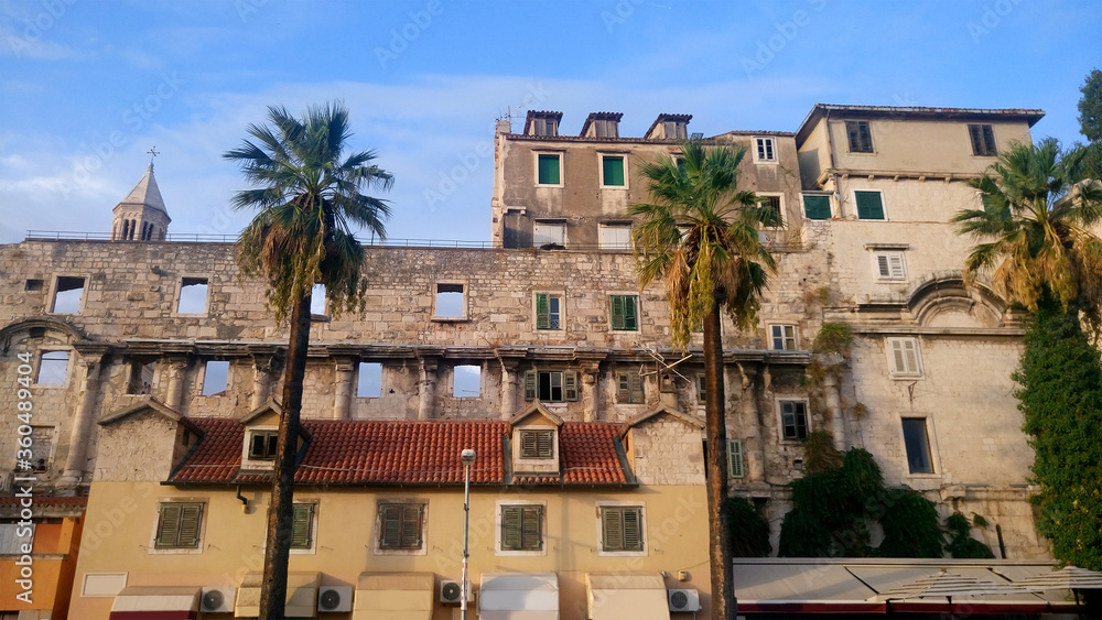 Old town in Split. Old architecture with palm trees. Croatia. Picture for postcard, advertisement, poster, mosaic.