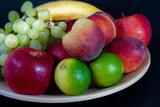 fruits on a plate with black background